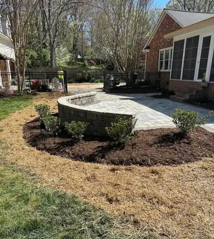 Circular patio area with pavers and landscaping work.